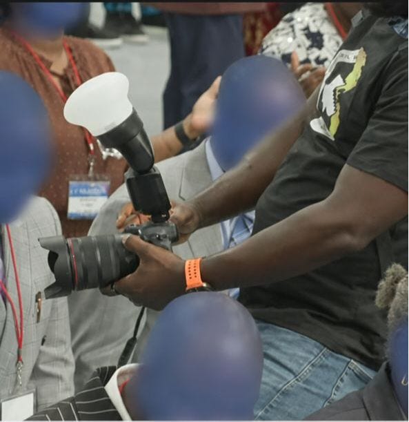Photographer taking a picture of someone in a crowd