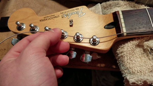 How to lock your guitar strings in place so they always stay in tune… Even  if you don't have locking tuners | by David Paras | Medium