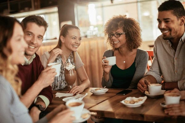 Group of friends enjoying company — Photographer Unknown