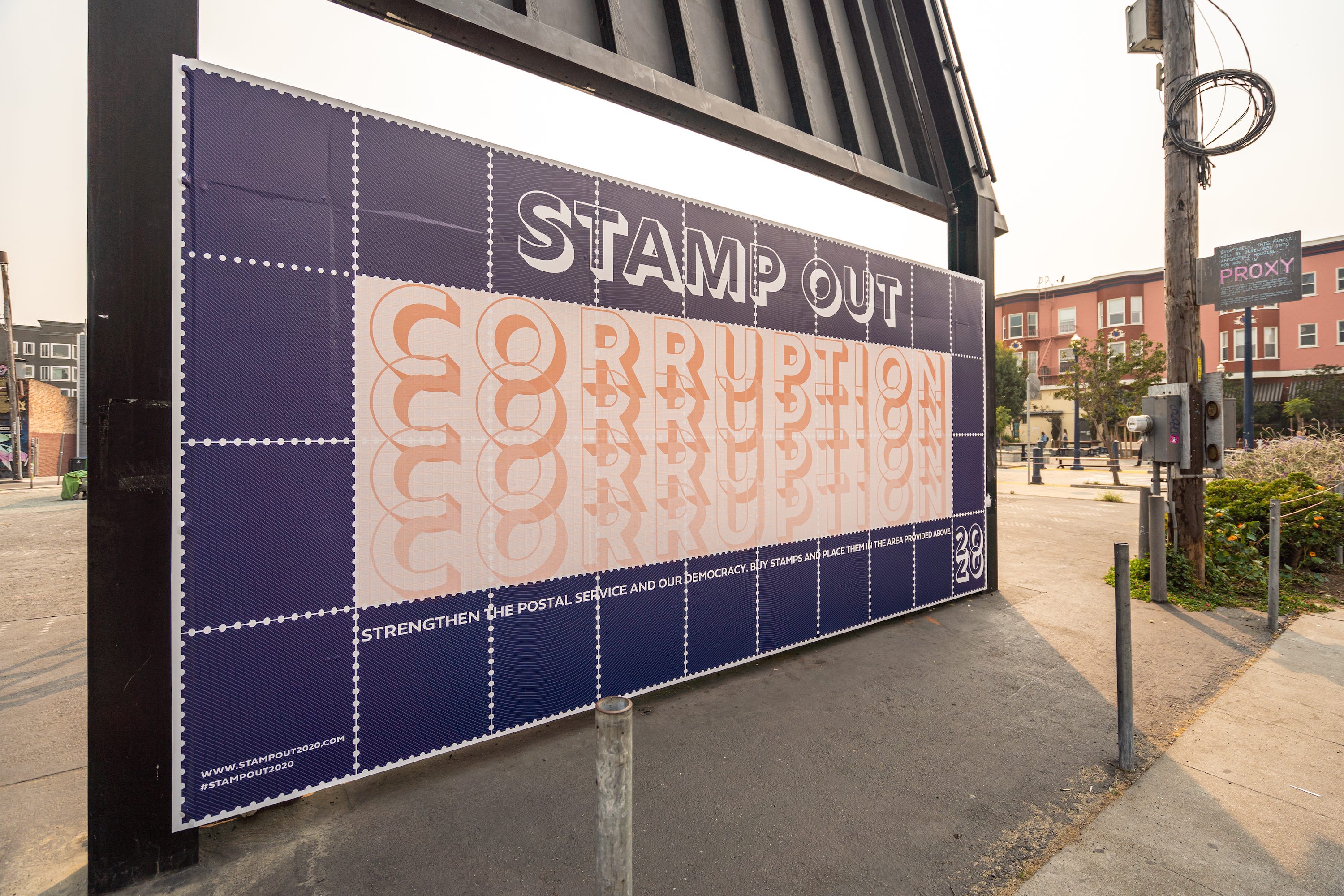 A sign that says “stamp out corruption” on a blue field that looks like a sheet of postal stamps.