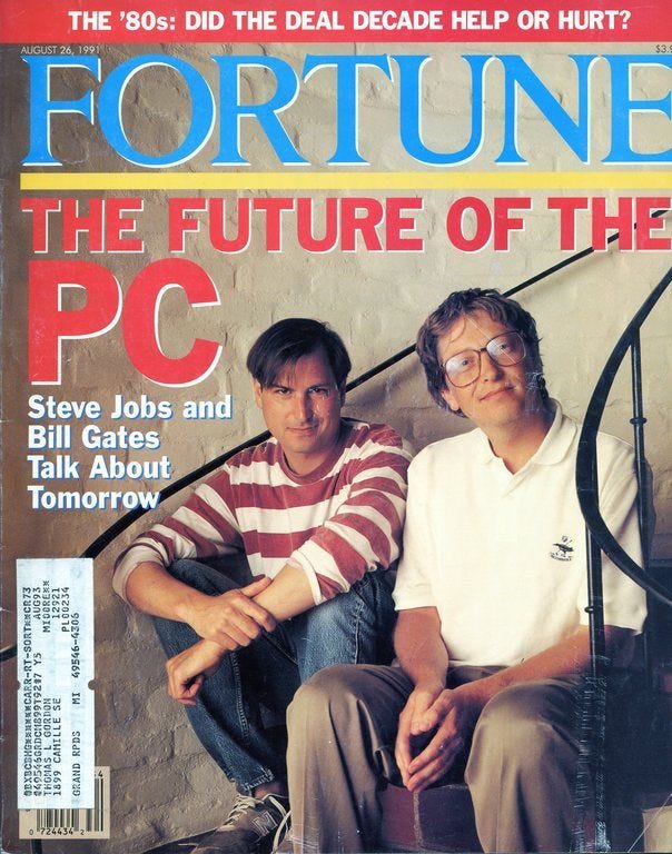 A Fortune magazine cover shows a young Steve Jobs and Bill Gates sitting on a staircase.