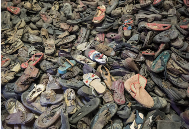 shoes collected outside Auschwitz, where prisoners were led inside under the pretense of showering and cleansing themselves, only to be murdered minutes later.
