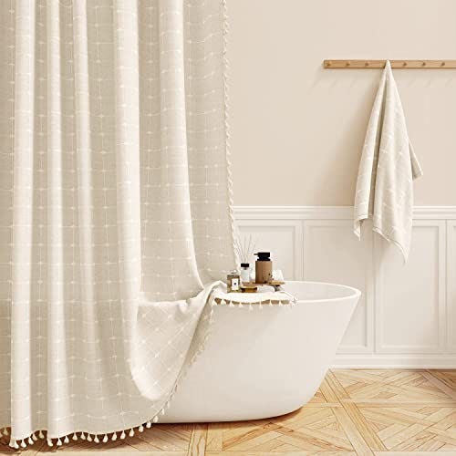 A modern bathroom with a white tub and a shower curtain.