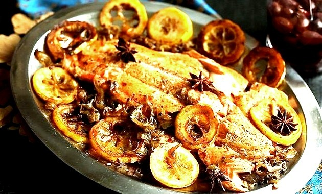 Salmon baked in foil packets is a healthy fish preparation method because it requires no additional fat during baking. Here, onions, lemon, marjoram, and star anise are used to season the salmon.