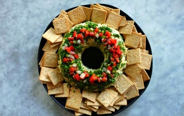 With a surprising taco-flavor, this rich and creamy cheese ball is shaped and decorated like a wreath so it’s perfect for your holiday table.