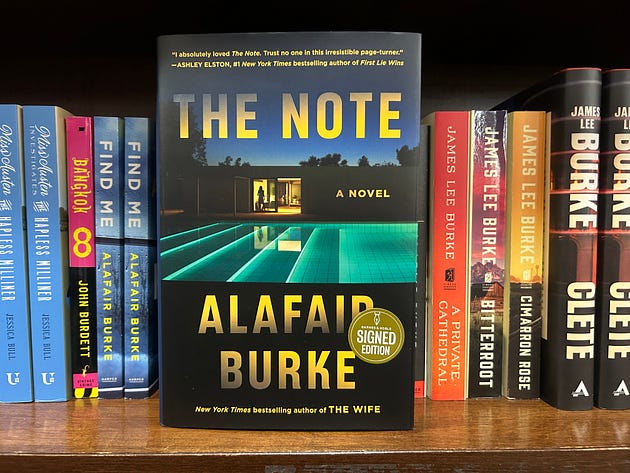 photo of Alafair Burke's The note on a book shelf with other words by her