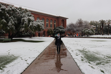 Woman posing on a sidewalk in the snwo.