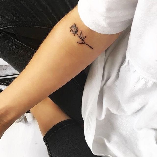 Single colored rose tattoo on a sleeve