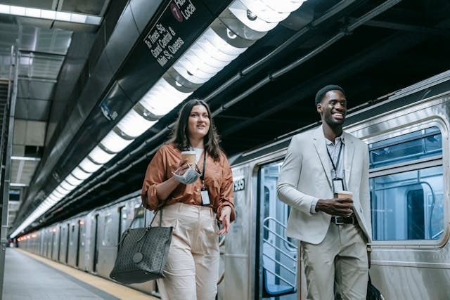Two person having conversation while walking in a metro subway.