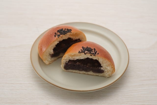 Japanese sweet buns called “Anpan,” filled with sweet red bean paste and topped with sesame seeds.