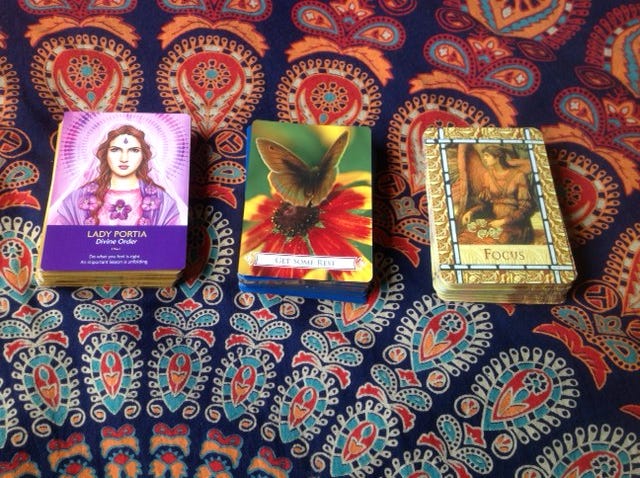 A tarot card spread with three cards laid out in a row, symbolizing hidden influences