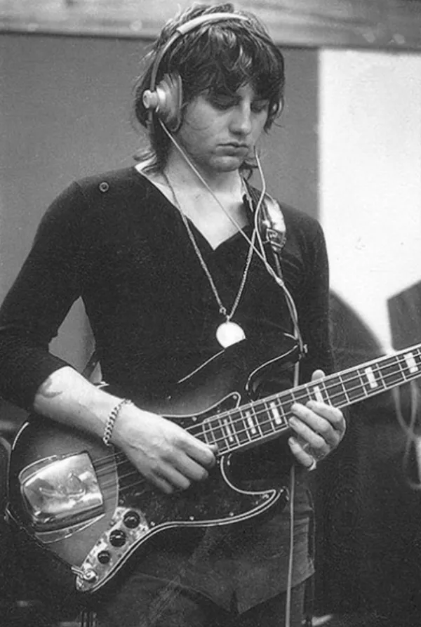 Bassist Greg Lake plays and listens during recording sessions.