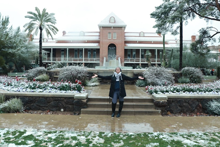 Woman posing in a garden.