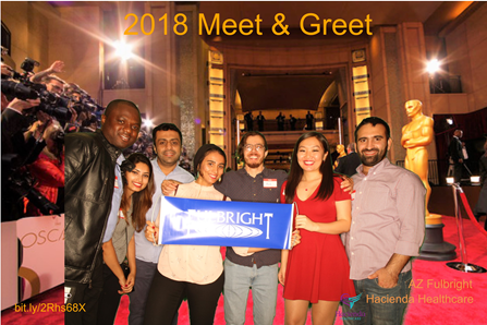 People on a fake red carpet holding a Fulbright sign.