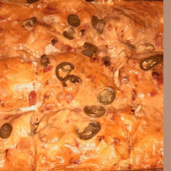 An easy, creamy chicken enchilada casserole. Slow cooking gently melds together the flavors of chicken thigh meat, cream of chicken soup, sour cream, and green chiles.