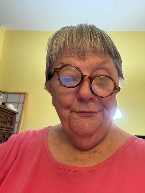 The author with crooked reading glasses making faces