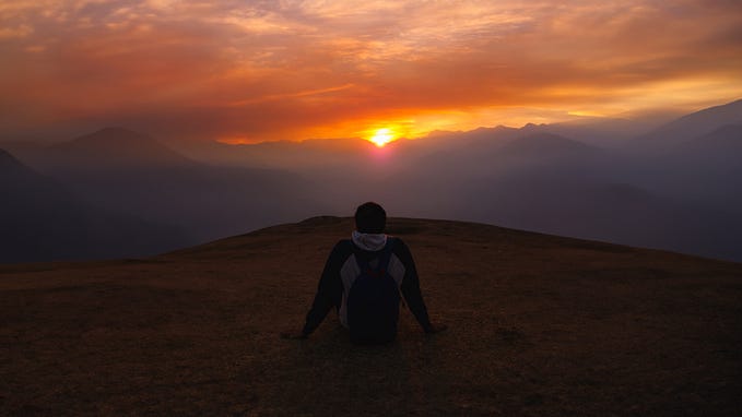 Header image of a person viewing the sunset
