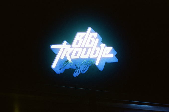 Big Trouble in neon letters.