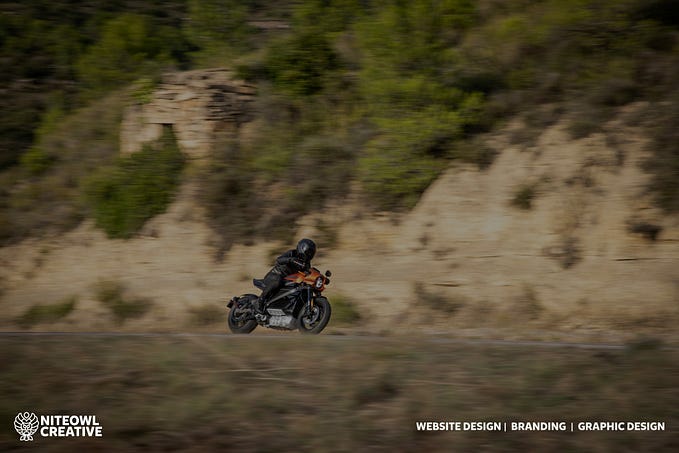 A motorcycle driving fast, with Niteowl Creative’s logo about website design