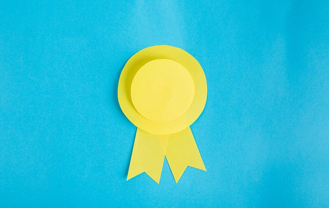 A yellow rosette set against a blue background