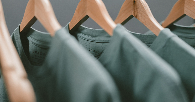Photograph of gray T-Shirts on hangers