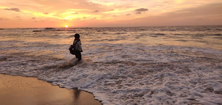 Woman walking on a beach.