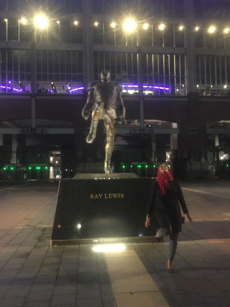 Woman posing like a sculpture of Ray Lewis.