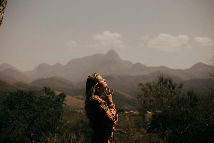 A woman casts her eyes to the sky, spiritually managing her fears.