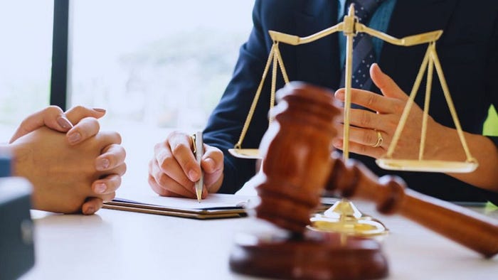 A family law attorney in Florida consults with a client in a courtroom setting, discussing legal matters.