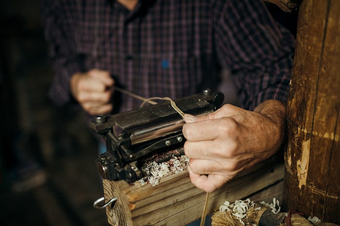 A jeweler working with metal wire.