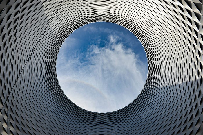 Picture of a view of the sky through a cylindrical, tessellated object