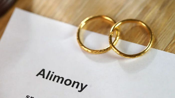 Two gold wedding bands resting on a document showing the word “Alimony,” symbolizing Florida’s spousal support options as discussed by S.G. Morrow & Associates, P.A.