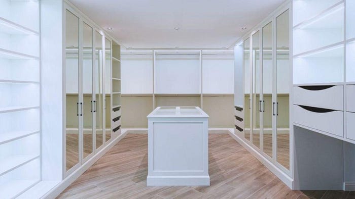 Large Walk-in Closet with Wooden Floors and Glass Closets