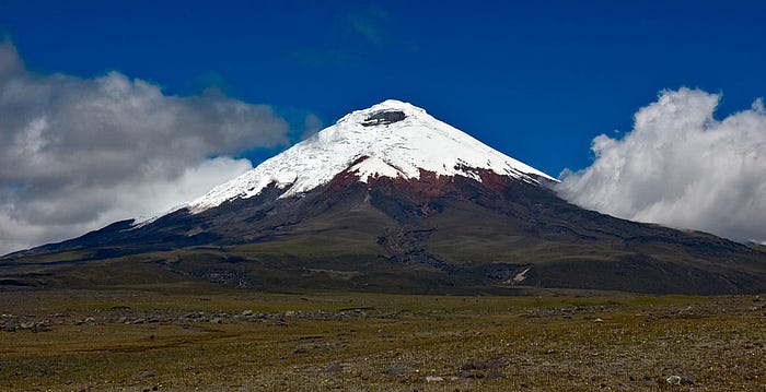 A photo of Mount Cotopaxi, Ecuador covered in a snow cap.