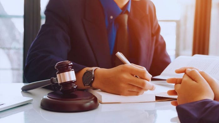 Alimony lawyer and client seated in an office, reviewing case details together.