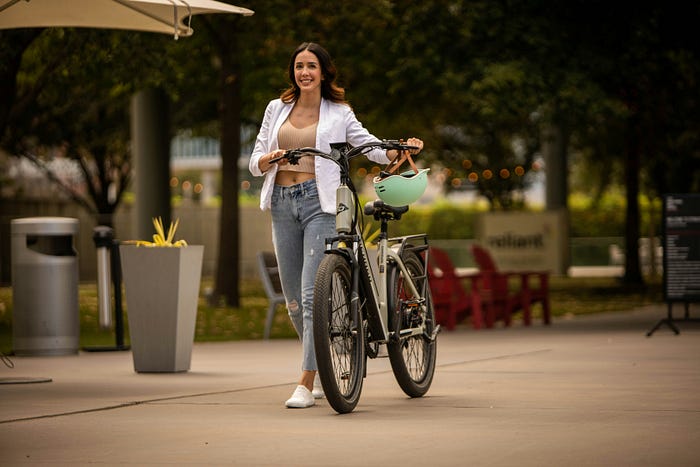 Smiling woman with a cycle.