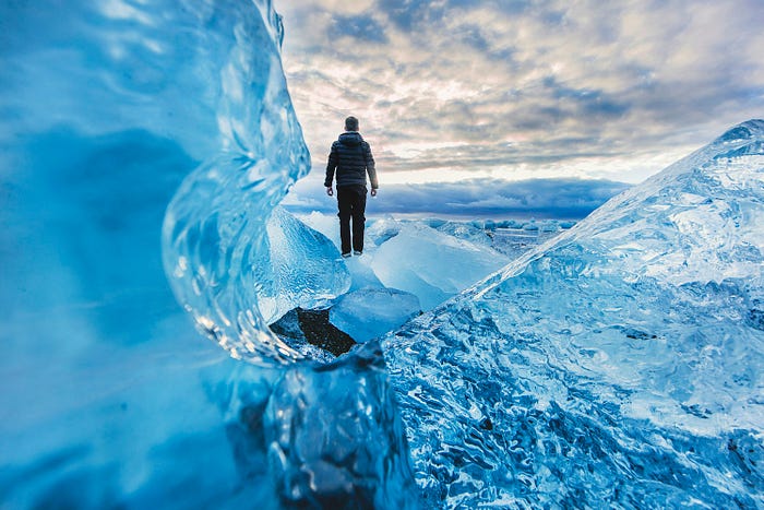 Man standing on a massive iceberg