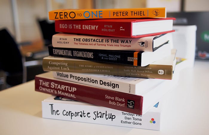 A pile of books about startups, mindset, and value propositions