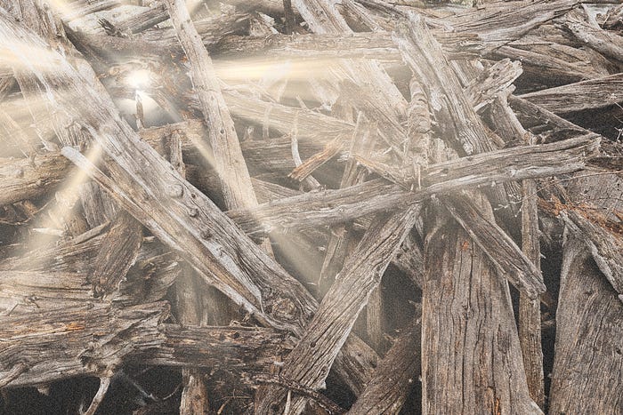 A jumbled logjam with beams of light pouring out of it