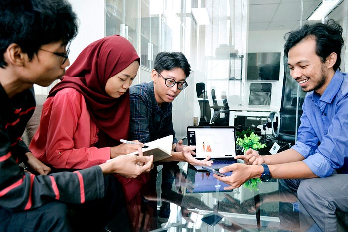 Office workers in Indonesia consider the interface for a mobile device.