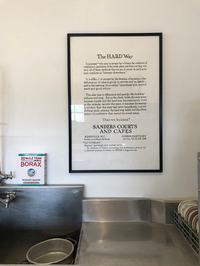 old slogan sign for Sanders Cafe