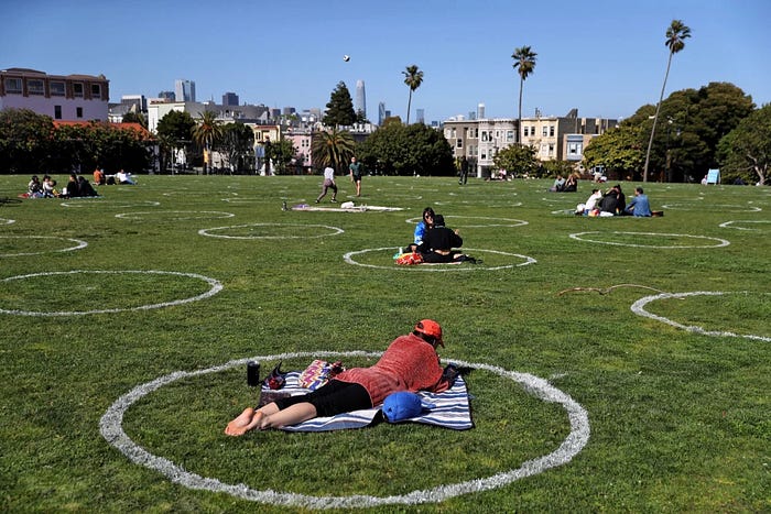 Visitors sit in social distancing circles at Dolores Park in San Francisco on Wednesday, May 20, 2020. — Justin Sullivan / Getty Images
