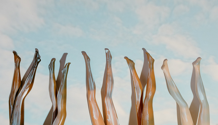 A group of mannequin legs in the air