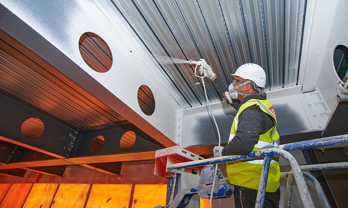 Intumescent fireproof coating applied on structural steel beams in Qatar construction site