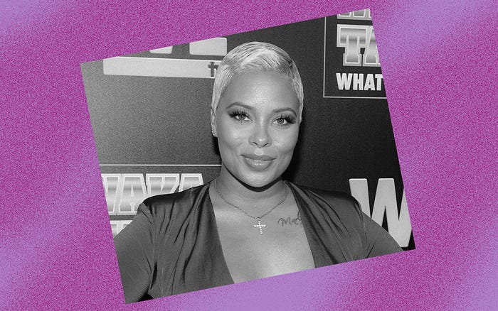 Black and white photo of Eva Marcille against a violet background.
