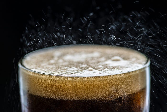 Image of a glass of Cola with thousand of bubbles as a representation of the amount of emotions that could elicits.
