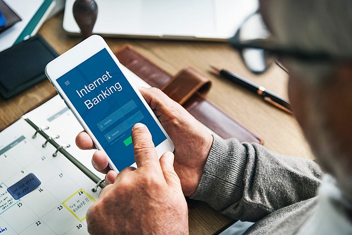 A person logs into their digital banking account on their phone.