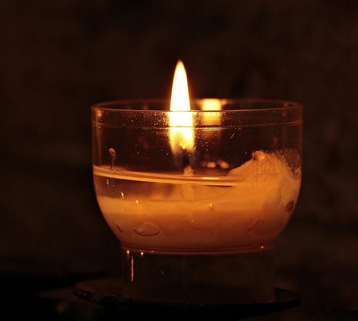 a memorial candle burning Trump protest memorial