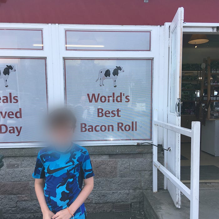 Window at The Horn with “World’s Best Bacon Roll” message on it.