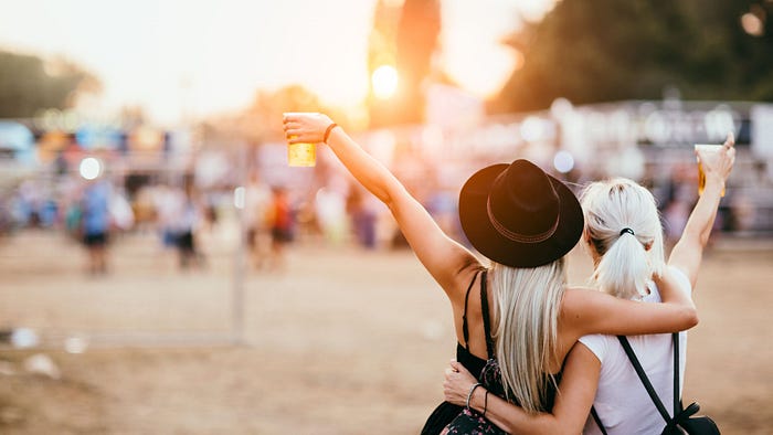 two rave buddies holding each other